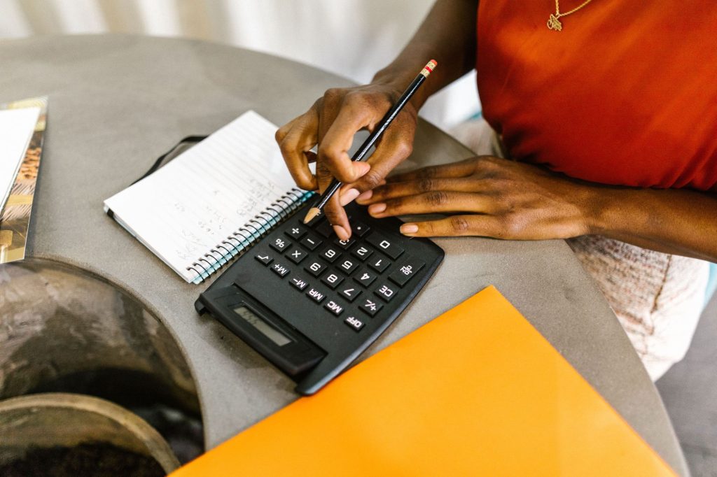 Business owner working out costs on a calculator